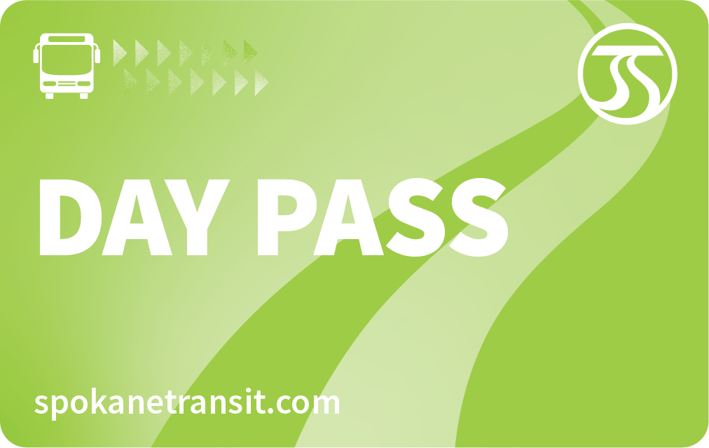 A green Spokane Transit day pass card featuring a bus icon, a series of small arrows, and the Spokane Transit logo in the top right corner is part of the STA Community Access Program. The text "DAY PASS" is prominently displayed, with "spokanetransit.com" at the bottom.