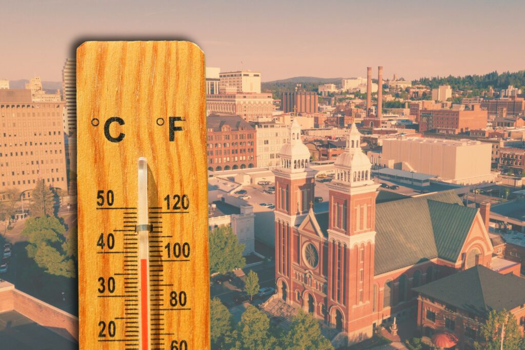 A thermometer showing high temperatures with a Spokane cityscape in the background.