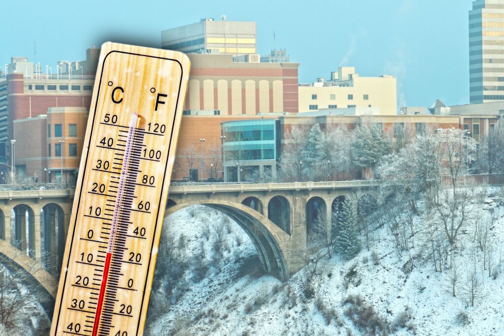 Thermometer over Monroe Street bridge and buildings, showing cold temperatures in Celsius and Fahrenheit.