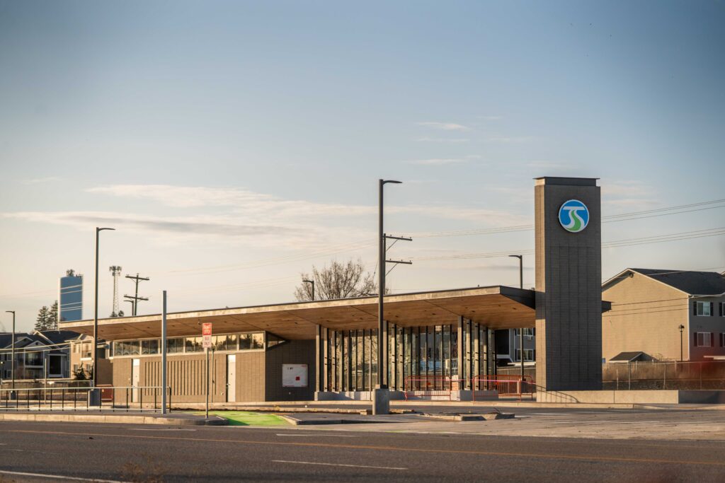 Mirabeau Transit Station with a tall signpost, large windows, and a calm sky in the background.