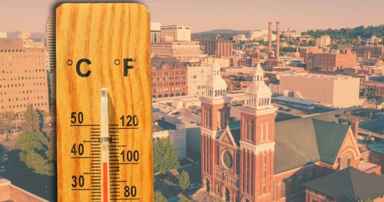 A thermometer showing high temperatures with a Spokane cityscape in the background.